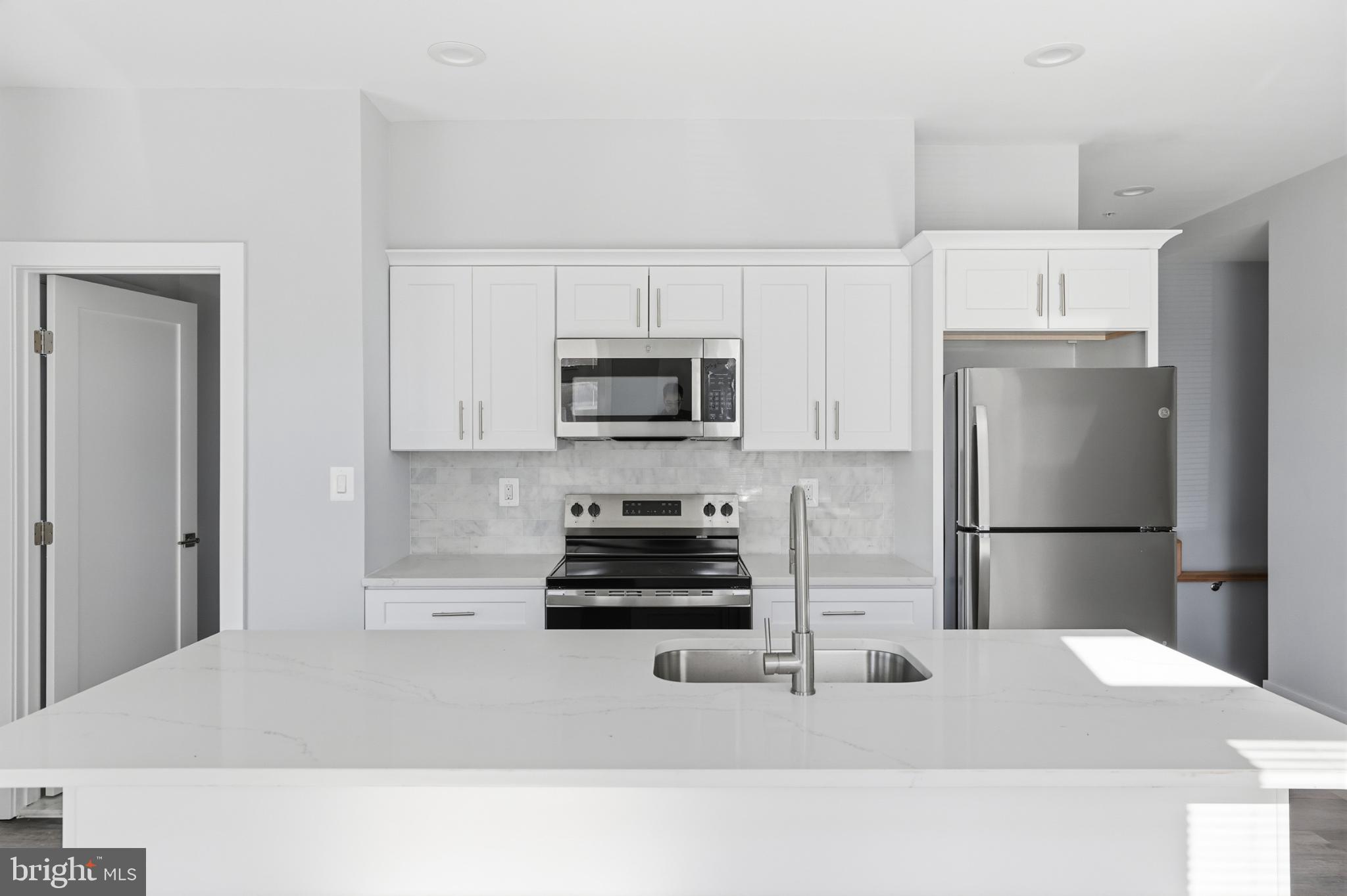 2600 4th Street Northeast, Unit A Washington, DC 20002 - Photo 7 of 33 a kitchen with a refrigerator and a stove top oven