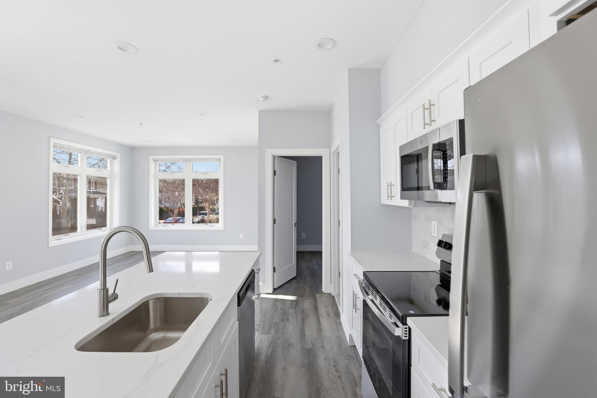 2600 4th Street Northeast, Unit A Washington, DC 20002 - Photo 8 of 33 a kitchen with stainless steel appliances granite countertop a sink stove and refrigerator