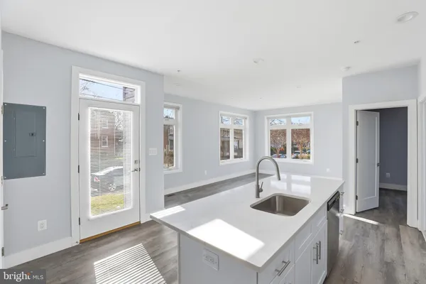 a kitchen with granite countertop a sink and a window