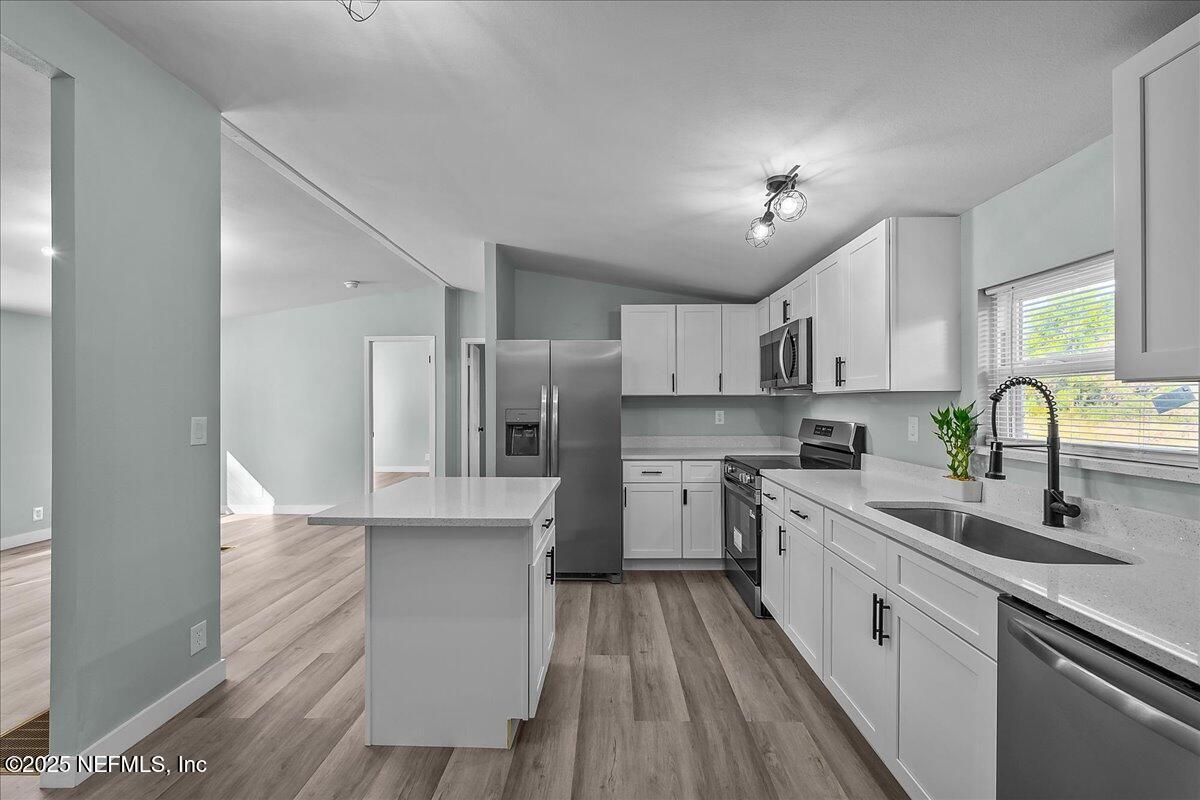 316 Sheila Avenue Interlachen, FL 32148 - Photo 11 of 22 a kitchen with white cabinets appliances and sink