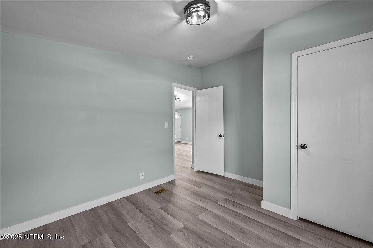 316 Sheila Avenue Interlachen, FL 32148 - Photo 20 of 22 a view of an empty room with wooden floor