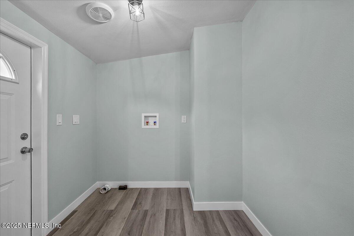 316 Sheila Avenue Interlachen, FL 32148 - Photo 21 of 22 a view of a room with wooden floor