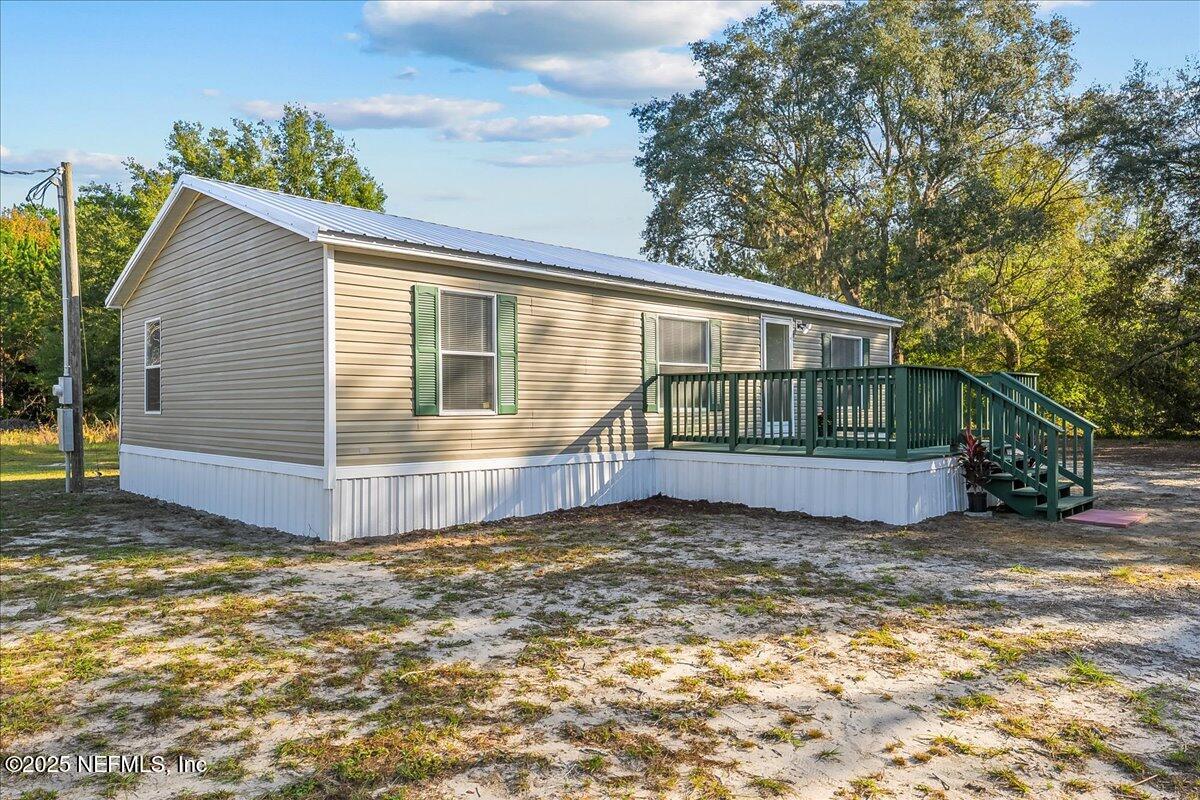 316 Sheila Avenue Interlachen, FL 32148 - Photo 4 of 22 a view of a house with a small yard and large tree