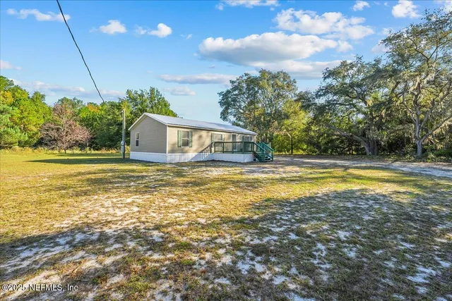 a house view with swimming pool and trees in the background