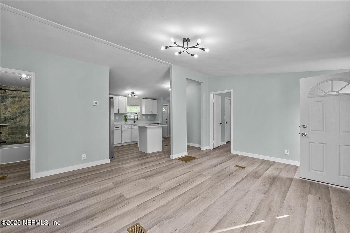 316 Sheila Avenue Interlachen, FL 32148 - Photo 9 of 22 a view of a livingroom with a kitchen