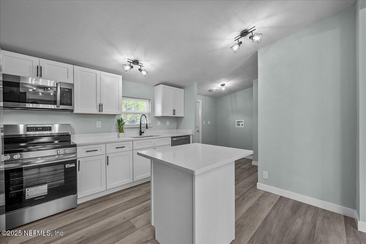 316 Sheila Avenue Interlachen, FL 32148 - Photo 10 of 22 a kitchen with kitchen island a sink stainless steel appliances and cabinets