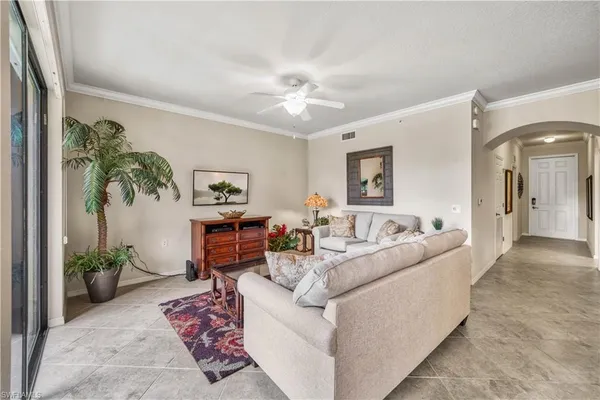 a living room with furniture and a potted plant