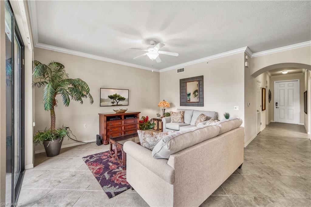 9715 Acqua Court, Unit 136 Naples, FL 34113 - Photo 11 of 24 a living room with furniture and a potted plant