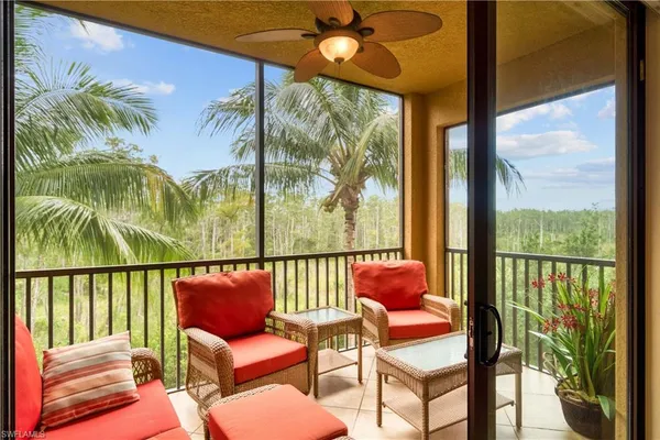 a balcony with furniture and a potted plant