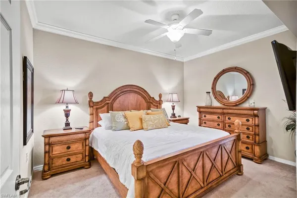 a bedroom with a bed a mirror and a chandelier