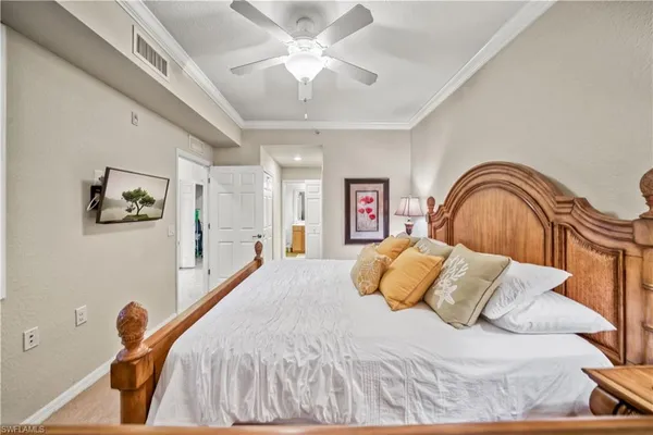 a bedroom with a bed and a painting on the wall