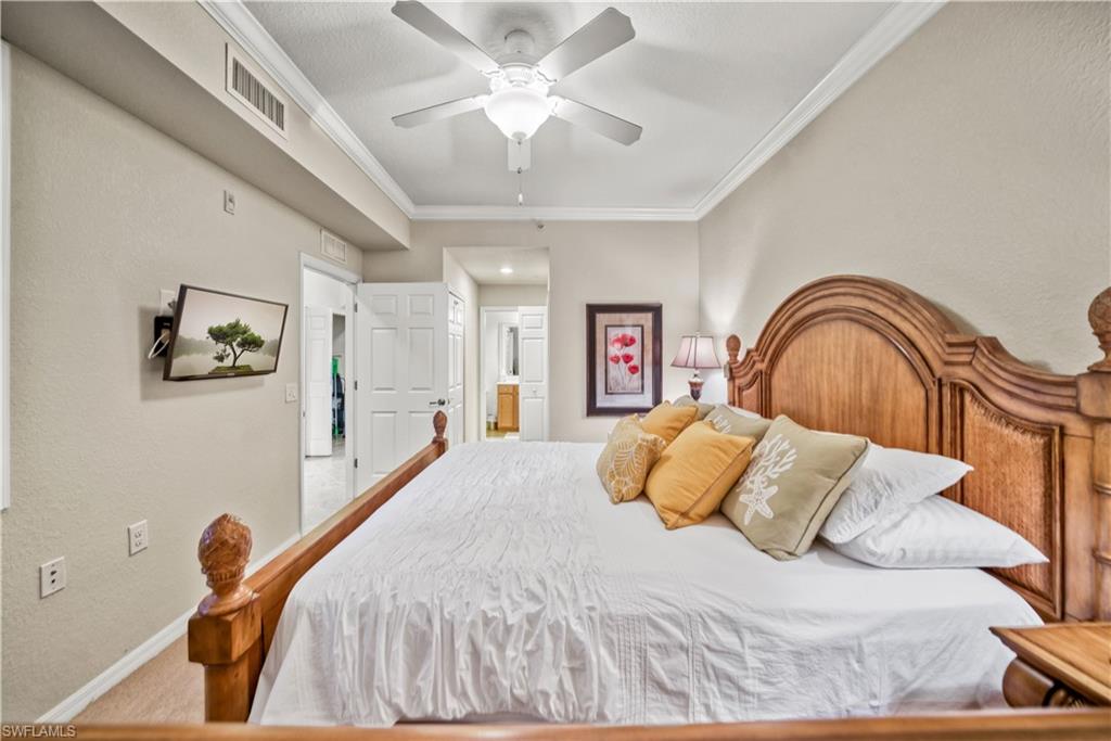 9715 Acqua Court, Unit 136 Naples, FL 34113 - Photo 15 of 24 a bedroom with a bed and a painting on the wall
