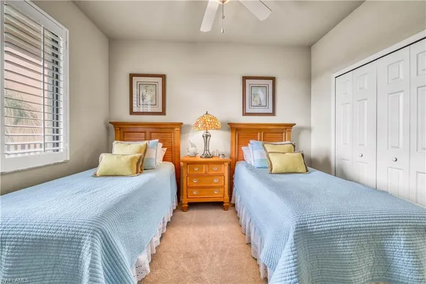 a bedroom with double bed and a window