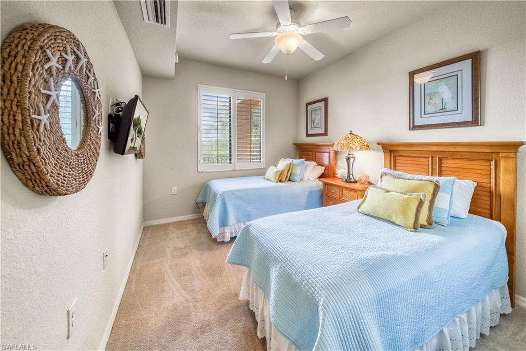 9715 Acqua Court, Unit 136 Naples, FL 34113 - Photo 19 of 24 a bedroom with double bed and a window