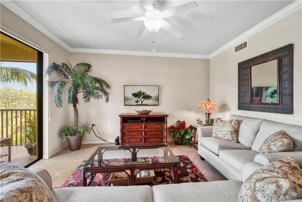 9715 Acqua Court, Unit 136 Naples, FL 34113 - Photo 2 of 24 a living room with furniture and a potted plant
