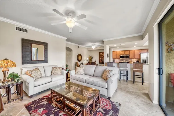 a living room with furniture and kitchen view