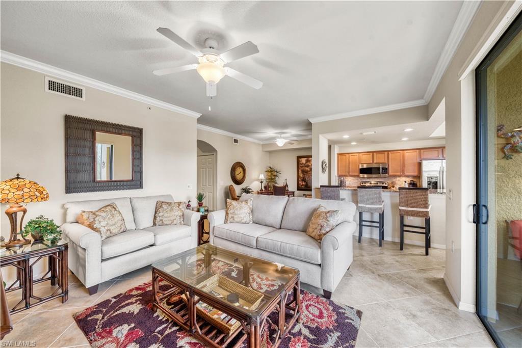 9715 Acqua Court, Unit 136 Naples, FL 34113 - Photo 3 of 24 a living room with furniture and kitchen view