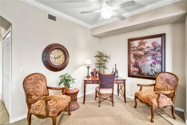 a living room with furniture a rug and a wall painting
