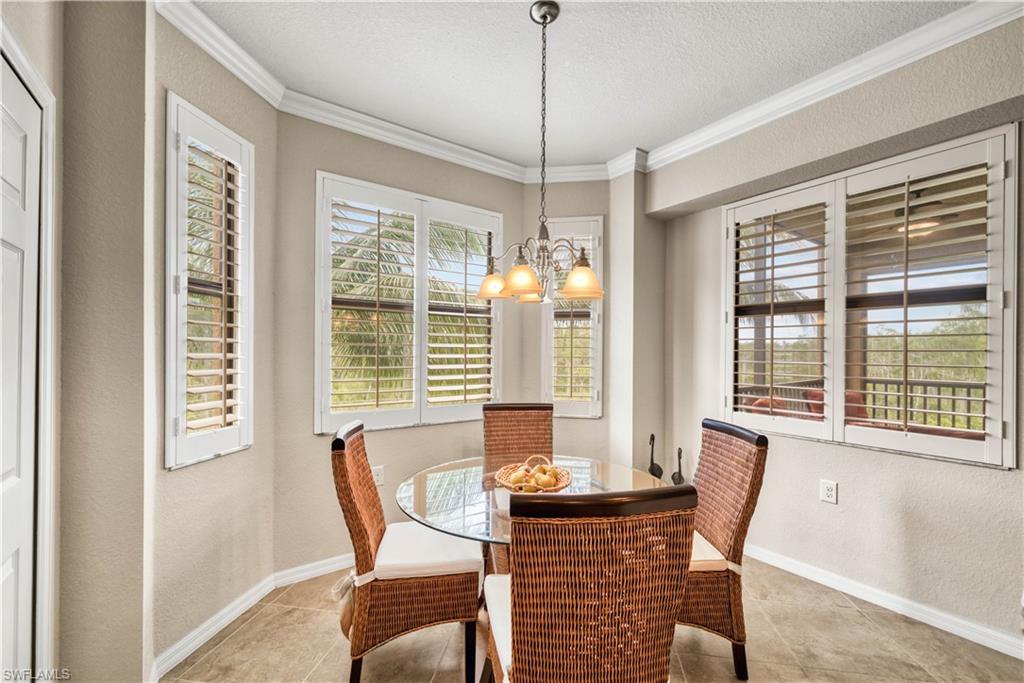 9715 Acqua Court, Unit 136 Naples, FL 34113 - Photo 8 of 24 a view of a dining room with furniture window and outside view