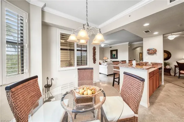 a living room with fireplace furniture and a chandelier