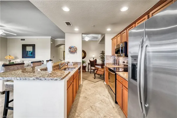 a large kitchen with stainless steel appliances lots of counter space and breakfast area