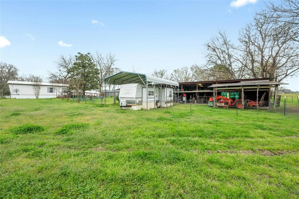 566 State Highway 95 Bastrop, TX 78602 - Photo 24 of 32 a front view of a house with a yard table and chairs