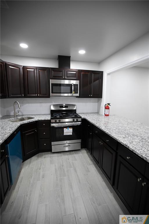 3402 Hana Road Edison, NJ 08817 - Photo 10 of 17 a kitchen with stainless steel appliances kitchen island granite countertop a stove a sink and a refrigerator
