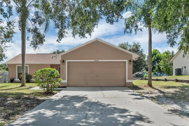 a front view of a house with a yard and a garage