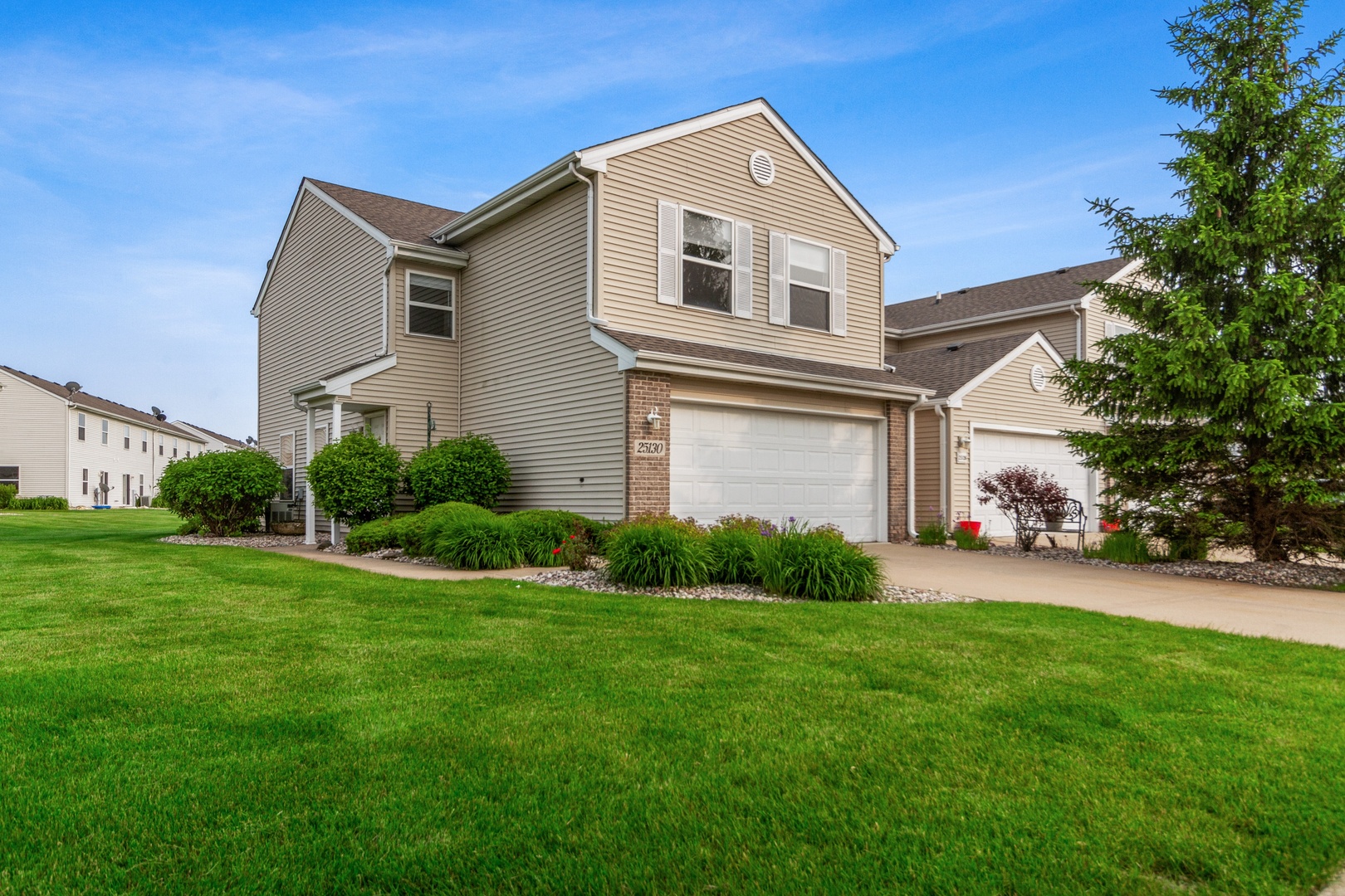 25130 Faraday Road Manhattan, IL 60442 - Photo 1 of 15 a front view of a house with a yard and garage