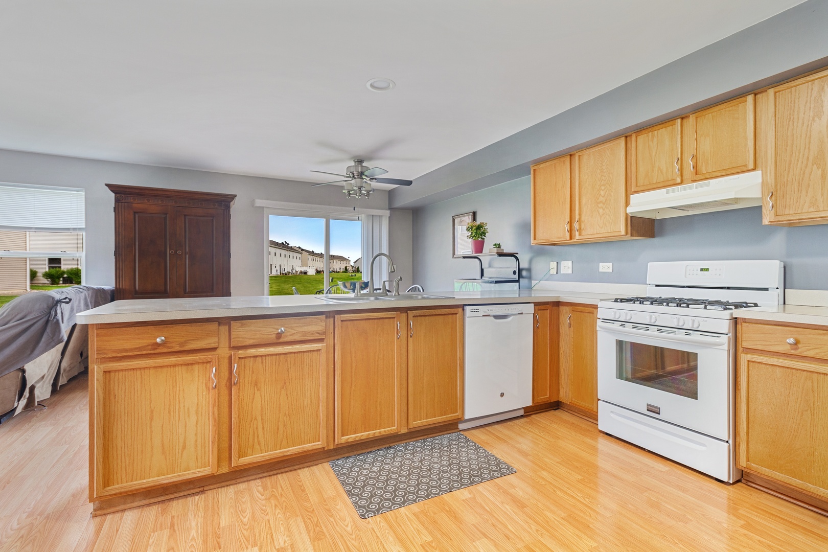 25130 Faraday Road Manhattan, IL 60442 - Photo 6 of 15 a kitchen with granite countertop white cabinets and white appliances