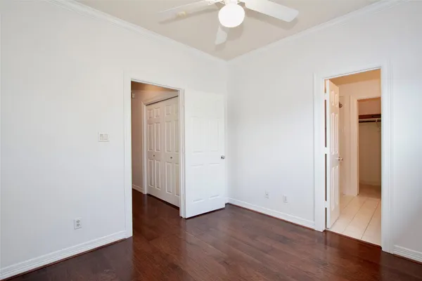 an empty room with wooden floor and closet