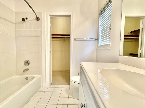 a bathroom with a tub a sink and a large window
