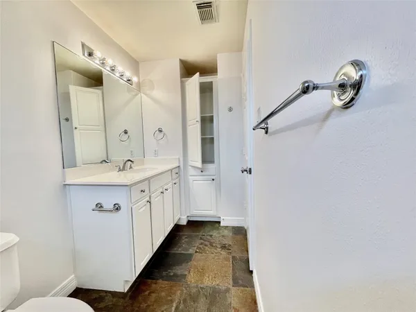 a bathroom with a double vanity sink and mirror