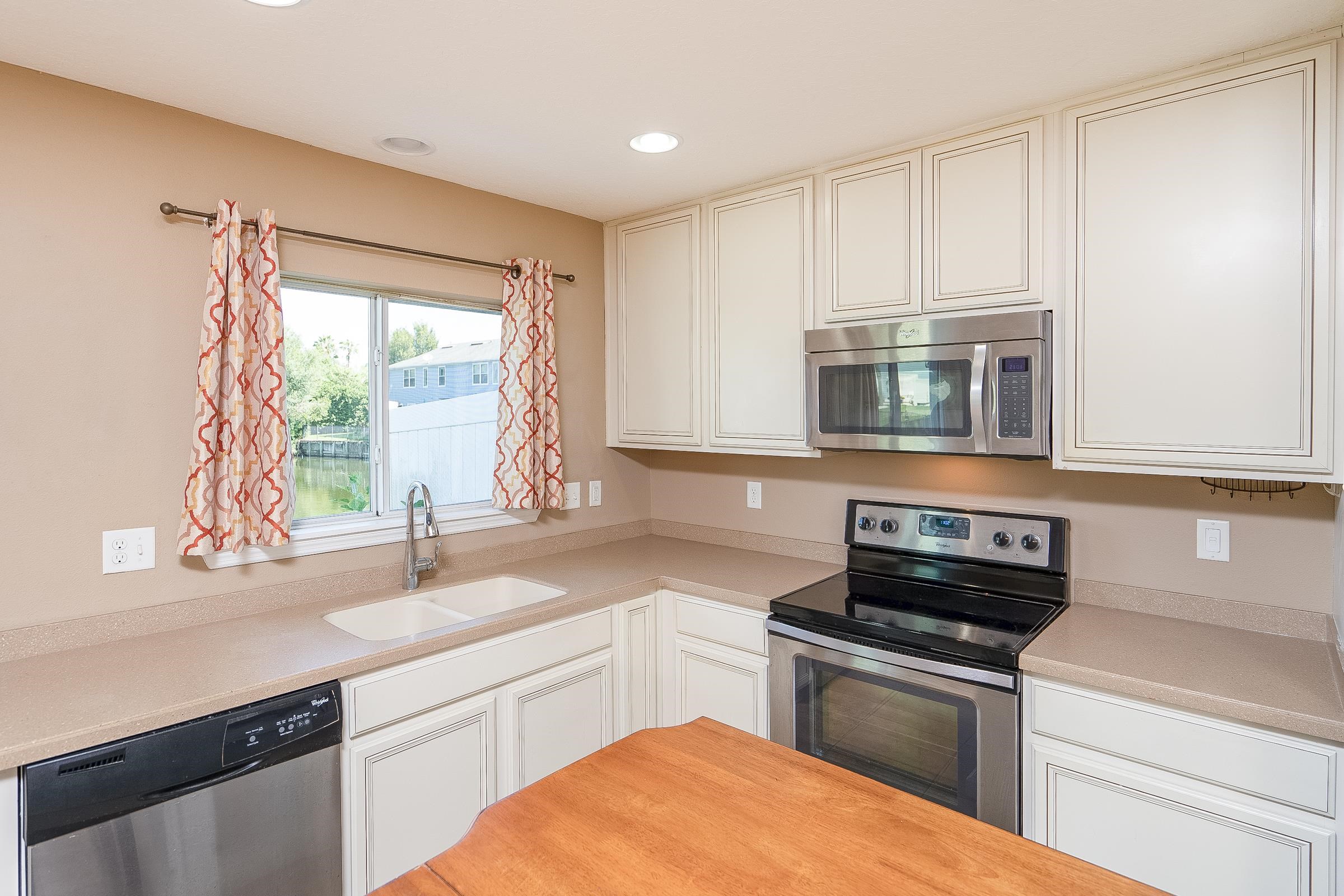 183 Islander Drive St. Augustine, FL 32080 - Photo 17 of 36 a kitchen with a sink cabinets appliances and a window