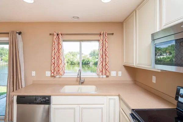 a view of a kitchen with a sink and a chandelier
