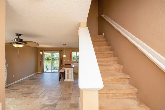 a view of a lake with a swimming pool and outdoor seating