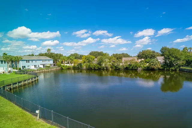 a view of a lake with a house in the background