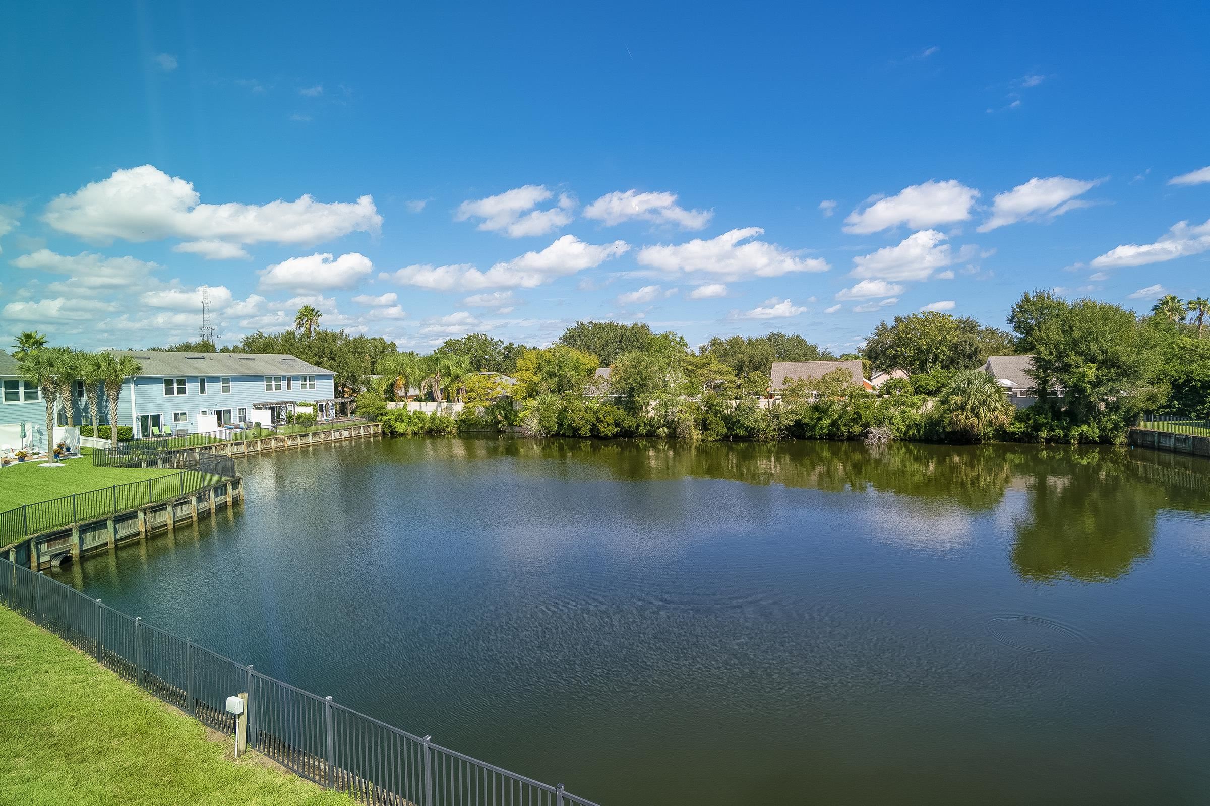 183 Islander Drive St. Augustine, FL 32080 - Photo 2 of 36 a view of a lake with a house in the background