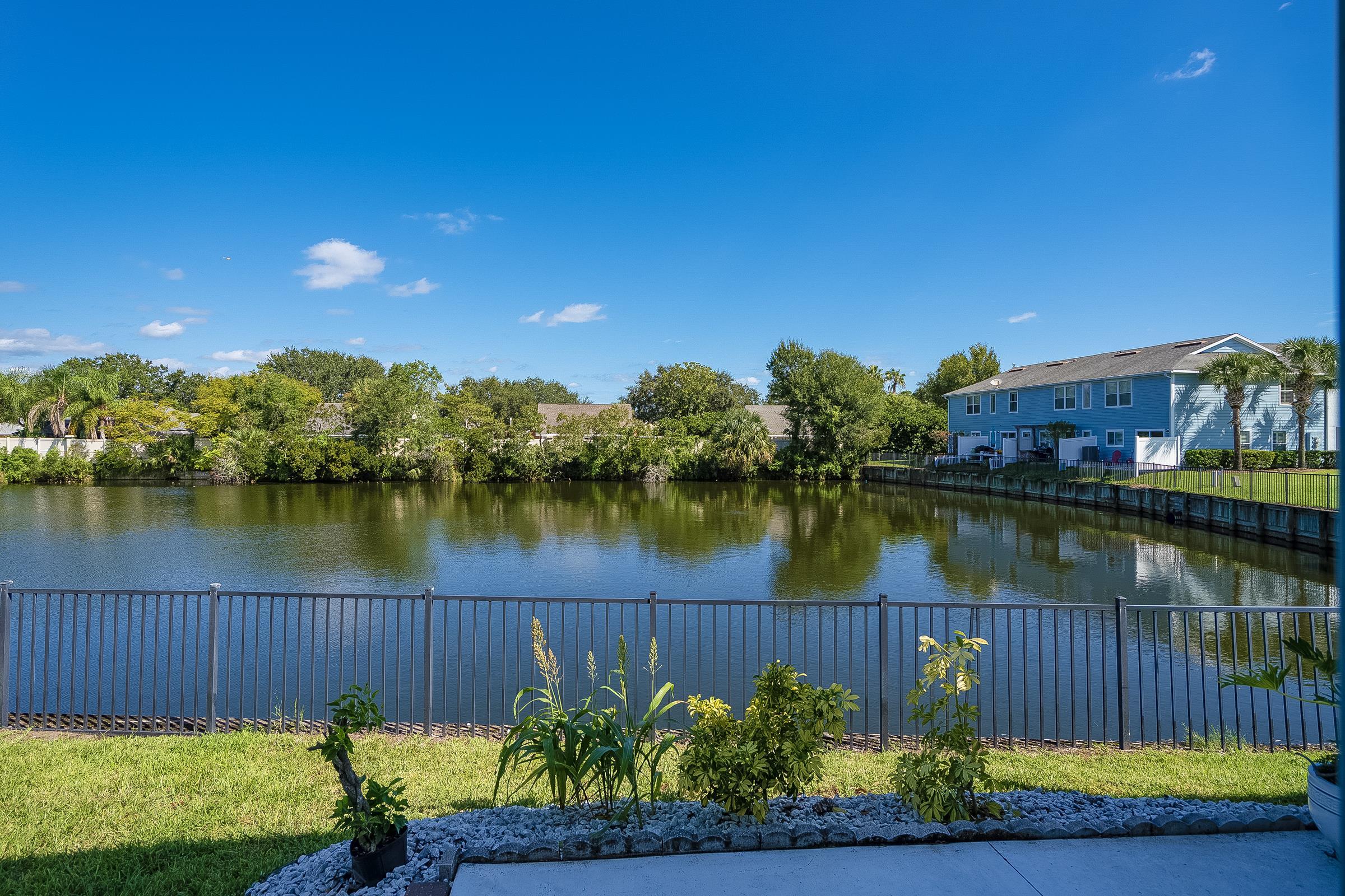 183 Islander Drive St. Augustine, FL 32080 - Photo 21 of 36 a view of a lake with a swimming pool and outdoor seating