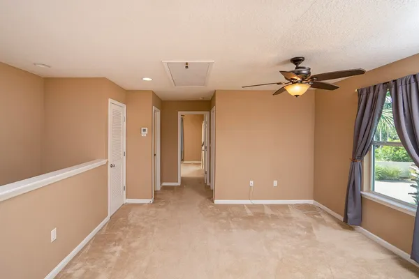 a view of a livingroom with a ceiling fan and window