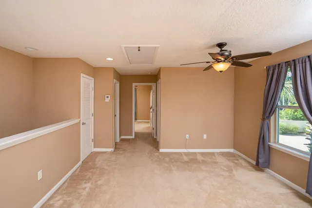 a view of a livingroom with a ceiling fan and window