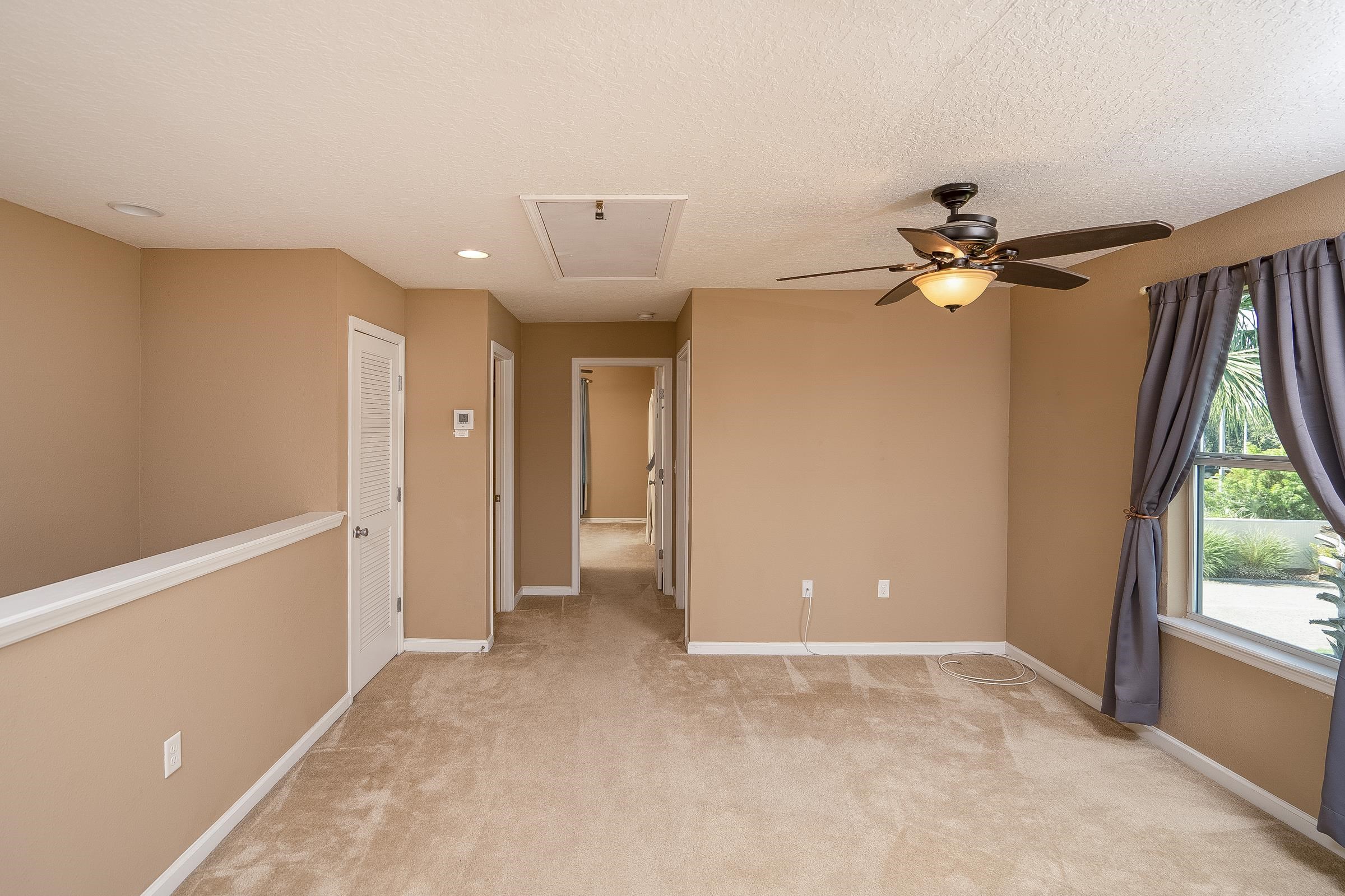 183 Islander Drive St. Augustine, FL 32080 - Photo 23 of 36 a view of a livingroom with a ceiling fan and window