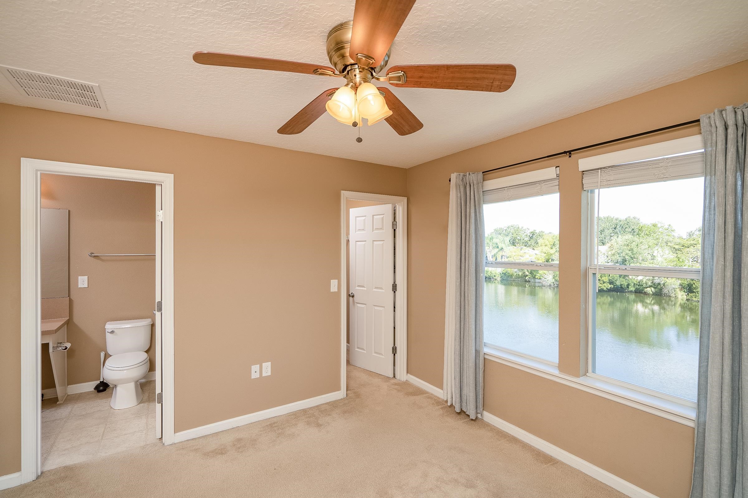 183 Islander Drive St. Augustine, FL 32080 - Photo 26 of 36 a view of a big room with windows and chandelier fan