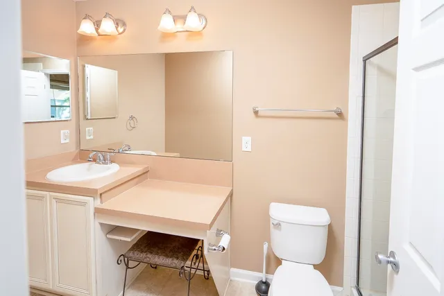 a white toilet sitting next to a bathroom sink