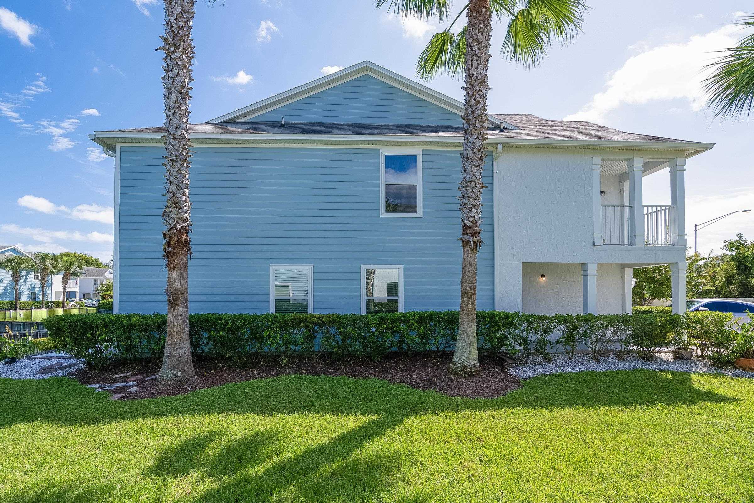183 Islander Drive St. Augustine, FL 32080 - Photo 5 of 36 a front view of a house with garden
