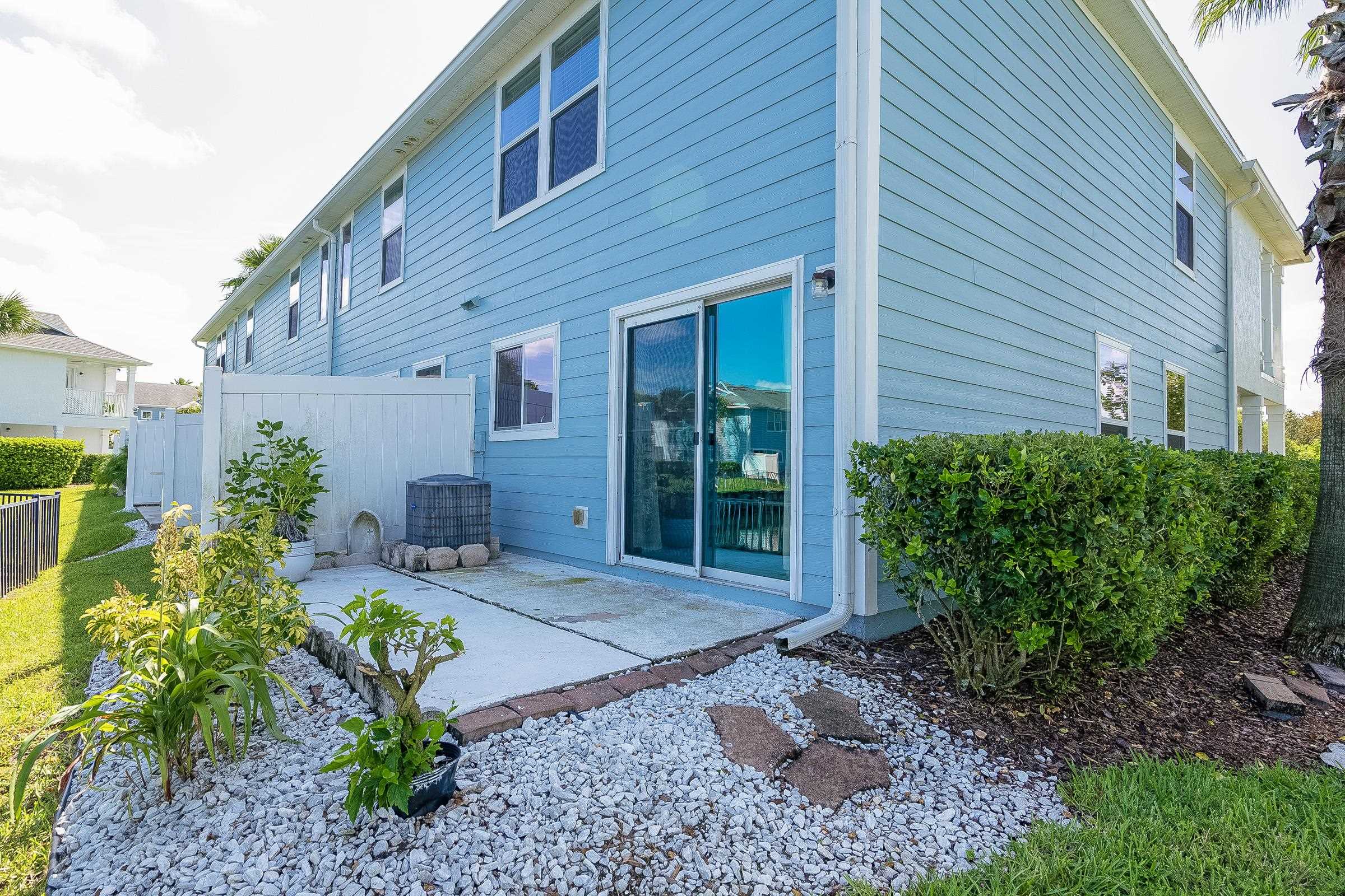 183 Islander Drive St. Augustine, FL 32080 - Photo 7 of 36 a front view of a house with garden