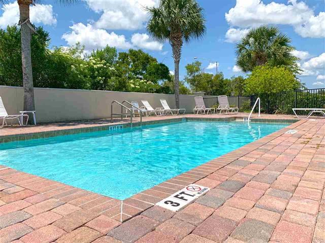 183 Islander Drive St. Augustine, FL 32080 - Photo 8 of 36 a view of a swimming pool with a patio and a yard