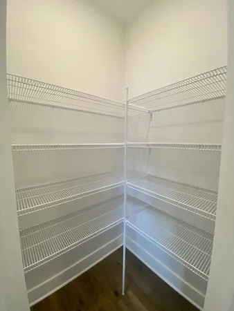 a view of walk in closet with empty racks