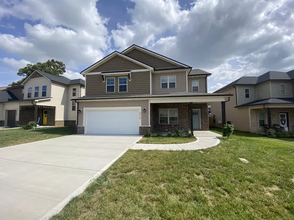 a front view of a house with a yard
