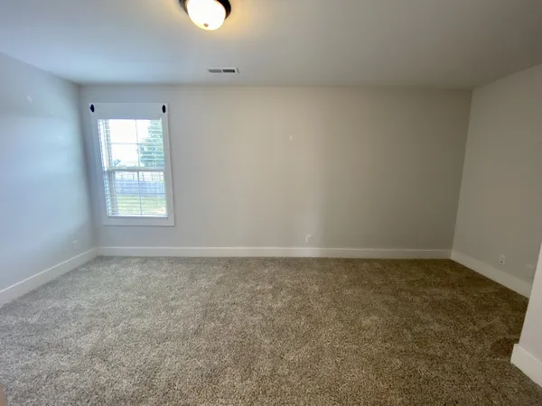 a view of an empty room and closet area